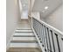 Clean stairway with modern black iron handrails and wood steps against white walls at 2500 Boone Ct, Sarasota, FL 34237