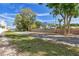 A street view near the property shows lush greenery and a glimpse of the neighborhood at 2500 Boone Ct, Sarasota, FL 34237