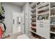 Custom walk-in closet offering tiered shelving and ample space for storage at 2500 Boone Ct, Sarasota, FL 34237