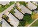 Overhead shot capturing the roofs of charming single-story homes nestled among lush greenery and palm trees at 2511 Lantana Ln, Palmetto, FL 34221