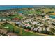 Panoramic aerial view of property nestled in a lush golf course community with beautiful water views at 2511 Lantana Ln, Palmetto, FL 34221