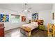 Bright bedroom featuring large window, ceiling fan, and modern decor at 2511 Lantana Ln, Palmetto, FL 34221