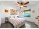 Stylish bedroom featuring a unique tapestry, modern ceiling fan, and ample natural light at 2511 Lantana Ln, Palmetto, FL 34221