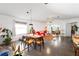 Open-concept living and dining area with modern lighting, polished concrete floors and view of the front yard at 2511 Lantana Ln, Palmetto, FL 34221