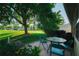Outdoor patio with seating area overlooking lush green space and trees at 2511 Lantana Ln, Palmetto, FL 34221