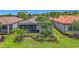 Aerial view of a home with a screened-in patio surrounded by lush landscaping and mature trees at 2525 Daisy Dr, North Port, FL 34289
