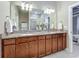 The bathroom features a double vanity with granite countertops, tile flooring, and updated vanity lights at 2525 Daisy Dr, North Port, FL 34289