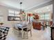 Cozy dining area with wooden table, stylish decor, and a view of the kitchen at 2525 Daisy Dr, North Port, FL 34289