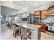 Spacious kitchen island with granite countertops, seating, stainless steel appliances, and modern lighting at 2525 Daisy Dr, North Port, FL 34289