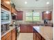 Modern kitchen featuring granite countertops, stainless steel appliances, and ample cabinet space at 2525 Daisy Dr, North Port, FL 34289