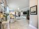 Bright living room with tile floors, a ceiling fan, and an open floor plan at 2525 Daisy Dr, North Port, FL 34289