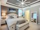 This main bedroom shows a stylish upholstered bench at the foot of the bed, and access to the main bathroom at 2525 Daisy Dr, North Port, FL 34289