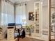 Office space with a functional desk and chair, natural light, and neutral walls, accessible through French doors at 2525 Daisy Dr, North Port, FL 34289