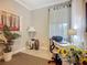 Bright office space featuring a functional desk and chair, natural light, neutral paint, and tile flooring at 2525 Daisy Dr, North Port, FL 34289