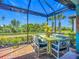 Inviting patio space with dining area, beautiful seating, and stunning views of the landscaped backyard at 2525 Daisy Dr, North Port, FL 34289
