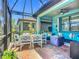 Beautiful covered patio with ample seating, dining area, and stylish decor for outdoor entertaining at 2525 Daisy Dr, North Port, FL 34289