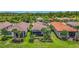 Beautiful villas featuring a well-manicured lawn and landscaping for outdoor living and privacy at 2525 Daisy Dr, North Port, FL 34289