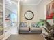This sitting room features neutral paint, a small sofa, and access to the primary bedroom through glass doors at 2525 Daisy Dr, North Port, FL 34289