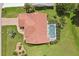 Aerial view of home with tile roof, screened pool, and lush landscaping at 25433 Colon Dr, Punta Gorda, FL 33983