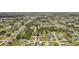 An aerial view showcases this property nestled in a neighborhood with mature trees and landscaping at 25433 Colon Dr, Punta Gorda, FL 33983