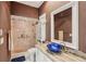 Bathroom with a glass enclosed shower, granite countertop, and a unique blue glass bowl sink at 25433 Colon Dr, Punta Gorda, FL 33983