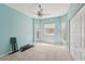 Bedroom featuring light blue walls, three windows and a ceiling fan at 25433 Colon Dr, Punta Gorda, FL 33983