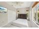 Bedroom with a ceiling fan, closet, and a large bed at 25433 Colon Dr, Punta Gorda, FL 33983
