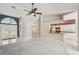 Open-concept living space with tile floors, modern lighting, and views into the adjacent kitchen and entryway at 25433 Colon Dr, Punta Gorda, FL 33983