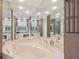 Luxurious bathroom featuring a soaking tub, vanity with ample mirror space, and neutral-toned walls at 25433 Colon Dr, Punta Gorda, FL 33983