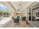 An inviting covered patio features a seating area, outdoor shower, and access to a screened-in pool at 25433 Colon Dr, Punta Gorda, FL 33983