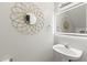 Modern half bath with decorative mirror and stylish vanity sink at 2553 Harn Blvd # 1, Clearwater, FL 33764