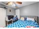 Bedroom with ceiling fan, blue patterned bedspread, desk, and computer at 2553 Harn Blvd # 1, Clearwater, FL 33764