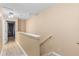 Hallway with neutral colored walls and floors and a white banister that leads to various rooms at 2553 Harn Blvd # 1, Clearwater, FL 33764