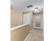 Hallway with neutral walls, modern light fixture, and wood-look flooring leads to various rooms at 2553 Harn Blvd # 1, Clearwater, FL 33764