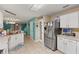 Kitchen featuring stainless steel refrigerator and access to dining area at 2553 Harn Blvd # 1, Clearwater, FL 33764
