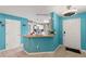 Kitchen bar with pendant lights, counter seating and white cabinets at 2553 Harn Blvd # 1, Clearwater, FL 33764