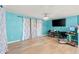Spacious living room with wood floors, a modern ceiling fan, and a large-screen TV at 2553 Harn Blvd # 1, Clearwater, FL 33764