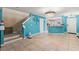 Open-concept living room with staircase, chandelier and open kitchen access at 2553 Harn Blvd # 1, Clearwater, FL 33764