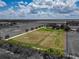 Aerial view outlining the property with vibrant green pastures, complemented by the tranquil and expansive surrounding landscape at 26147 L And J Rd, Myakka City, FL 34251