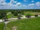 Vast property with a picturesque pond, lush pastures, mature trees, and serene landscaping at 26147 L And J Rd, Myakka City, FL 34251