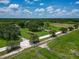 Sprawling property features a serene pond, pastures, mature trees, multiple structures, and lush greenery at 26147 L And J Rd, Myakka City, FL 34251