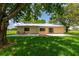 Charming backyard with a brick-accented patio, inviting atmosphere, and tranquil views of the surrounding landscape at 26147 L And J Rd, Myakka City, FL 34251
