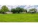 Spacious backyard with outbuildings and mature trees providing ample space for outdoor activities at 26147 L And J Rd, Myakka City, FL 34251