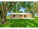 Picturesque backyard with a patio, well-maintained lawn, and mature trees, creating a serene and inviting outdoor space at 26147 L And J Rd, Myakka City, FL 34251