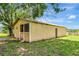 Exterior view of a well-kept barn featuring wooden details, set amidst green grass at 26147 L And J Rd, Myakka City, FL 34251