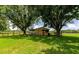 Exterior shot of barn between trees, showcasing its rural charm and functional design at 26147 L And J Rd, Myakka City, FL 34251
