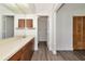 Bathroom featuring wood cabinets, a large mirror, a white countertop, and wood look flooring at 26147 L And J Rd, Myakka City, FL 34251