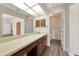 Bathroom featuring a large mirror over wood cabinets and a view into the toilet area at 26147 L And J Rd, Myakka City, FL 34251