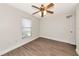 Bedroom featuring a ceiling fan, a window with blinds and wood look flooring at 26147 L And J Rd, Myakka City, FL 34251