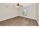 Bedroom with a ceiling fan, one window and wood look flooring at 26147 L And J Rd, Myakka City, FL 34251
